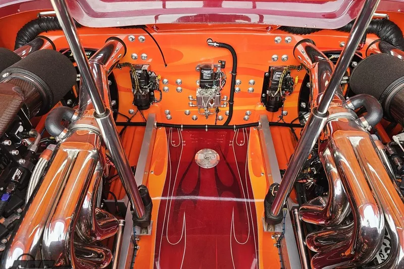 Slide: The Image of 2008 Eliminator 36 Daytona Coupe engine bay with polished chrome components and vibrant orange detailing. - 96