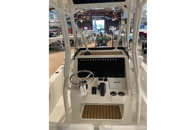 Slide: The Image of 2026 Ranger 2510 Bay boat console with steering wheel and controls in showroom. - 11