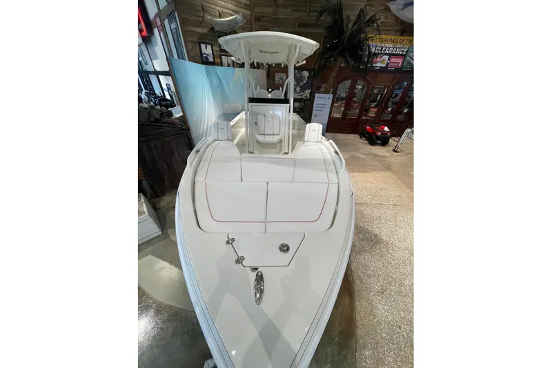 Slide: The Image of 2026 Ranger 2510 Bay boat displayed indoors, showcasing sleek design and spacious seating. - 2