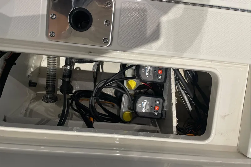 Slide: The Image of 2026 Ranger 2510 Bay boat compartment with wiring and hydraulic components visible. - 7