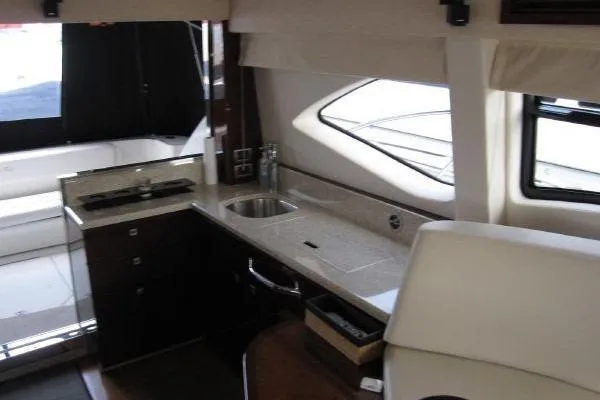 Slide: The Image of Interior of 2008 Sea Ray 47 Sedan Bridge yacht, featuring a modern kitchen area. - 11