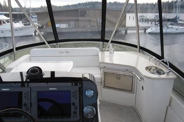 Slide: The Image of 2008 Sea Ray 47 Sedan Bridge helm with navigation controls and marina view. - 6