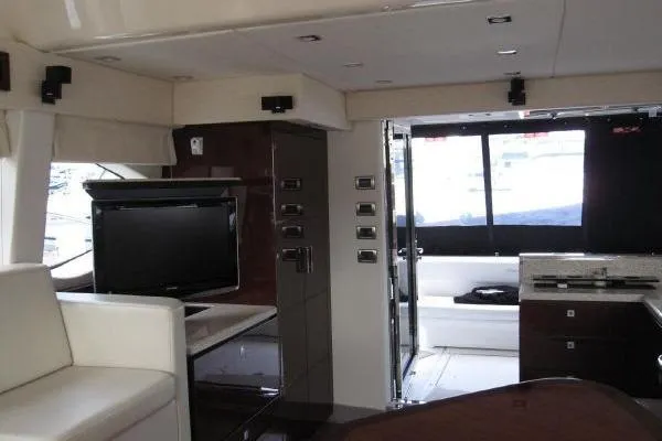 Slide: The Image of Interior of 2008 Sea Ray 47 Sedan Bridge yacht with modern furnishings and entertainment system. - 9