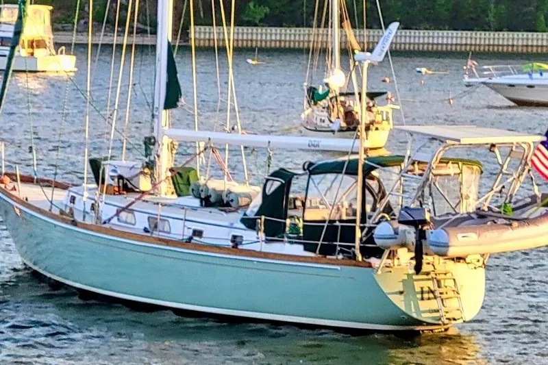 The Image of 1981 Bristol 45.5 Aft Cockpit sailboat anchored in a serene harbor setting. - 0