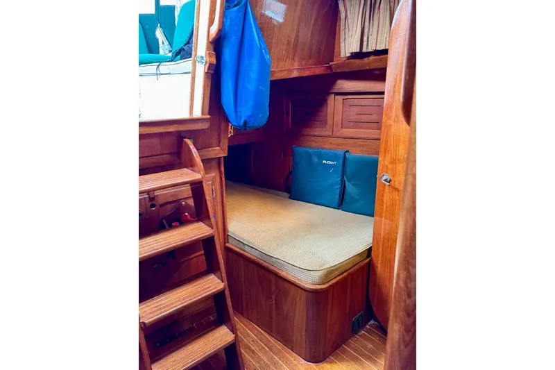 Slide: The Image of 1981 Bristol 45.5 Aft Cockpit interior with wooden finish and cozy sleeping area. - 18