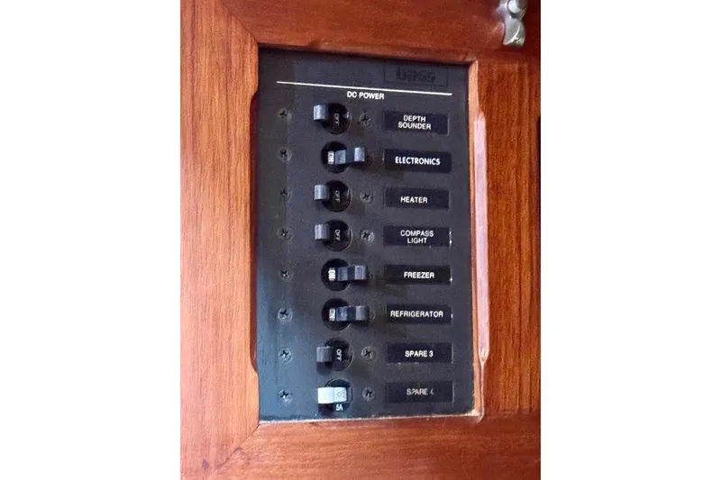 Slide: The Image of Electrical panel on 1981 Bristol 45.5 Aft Cockpit boat with labeled switches. - 21
