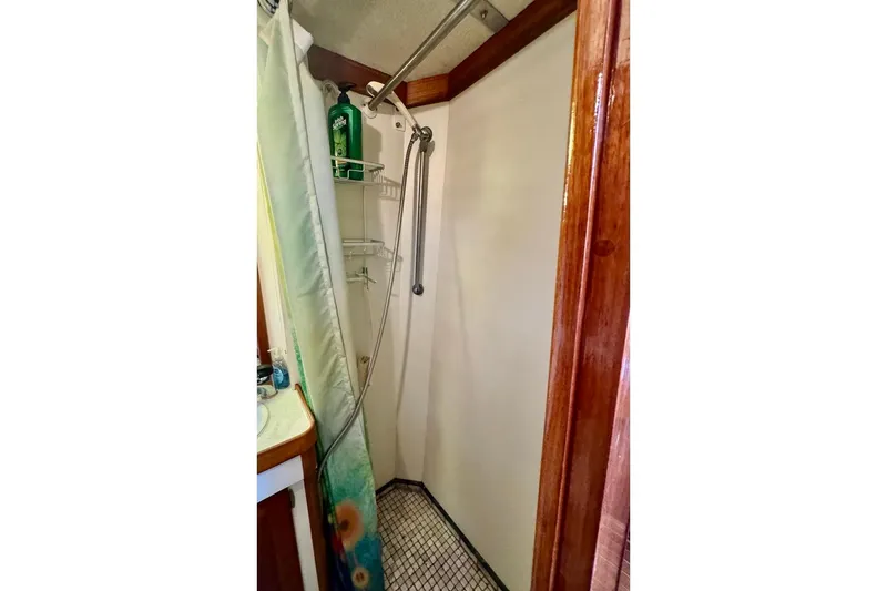 Slide: The Image of Shower area in 1981 Bristol 45.5 Aft Cockpit yacht with wooden trim and curtain. - 25