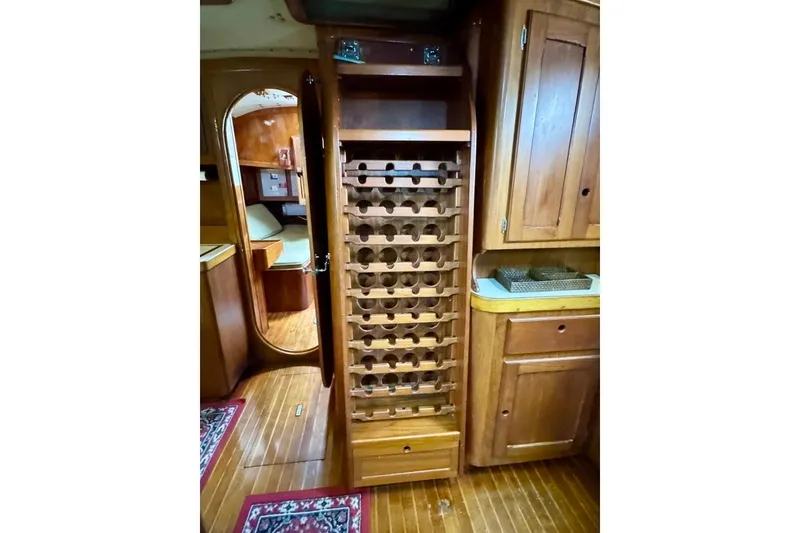 Slide: The Image of Interior of 1981 Bristol 45.5 Aft Cockpit yacht with wooden cabinetry and wine rack. - 31