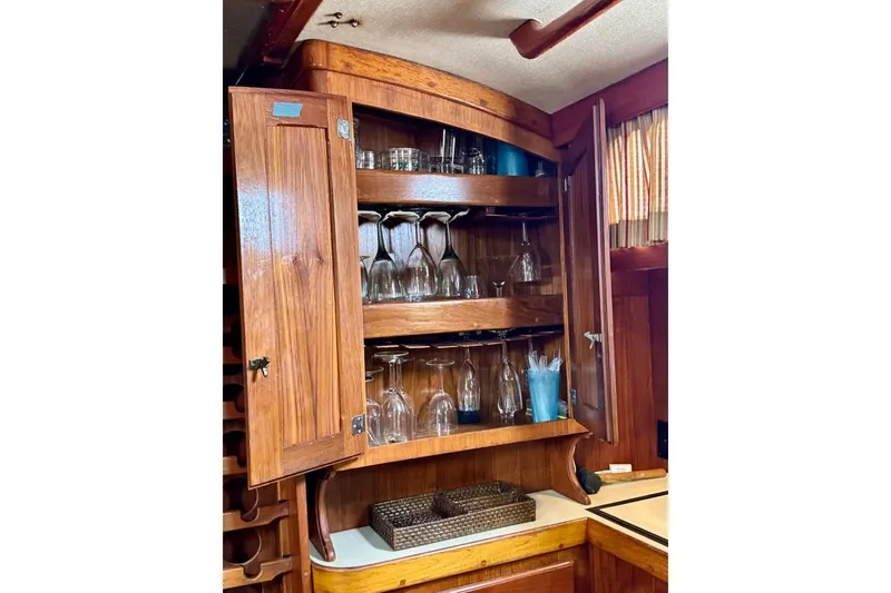 Slide: The Image of Wooden cabinet with glassware inside a 1981 Bristol 45.5 Aft Cockpit yacht. - 32