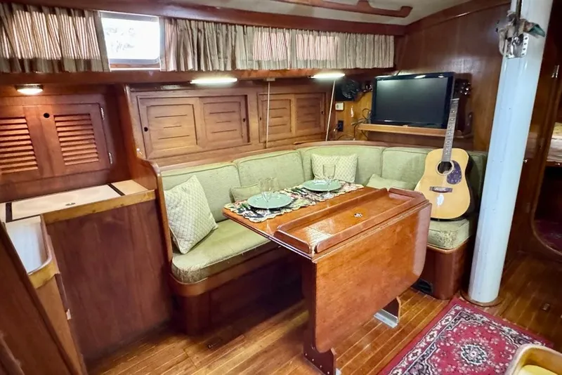 Slide: The Image of Interior of 1981 Bristol 45.5 Aft Cockpit yacht with cozy dining area and guitar. - 33