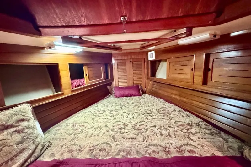 Slide: The Image of Cozy cabin interior of 1981 Bristol 45.5 Aft Cockpit with wooden paneling and patterned bedding. - 40