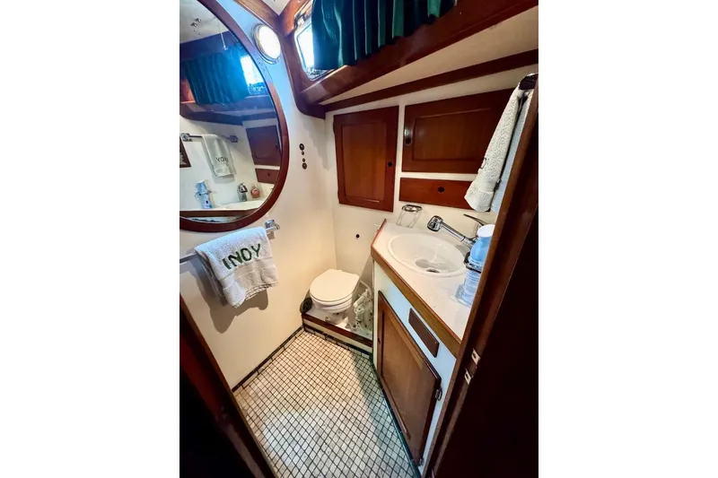 Slide: The Image of 1981 Bristol 45.5 Aft Cockpit yacht bathroom with wooden cabinets and tiled floor. - 41