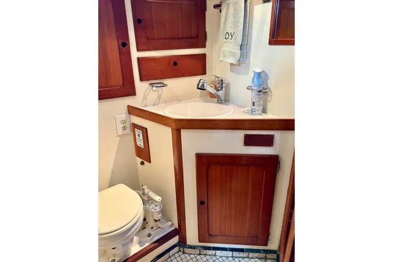 Slide: The Image of 1981 Bristol 45.5 Aft Cockpit yacht bathroom with wooden cabinets and compact sink. - 42