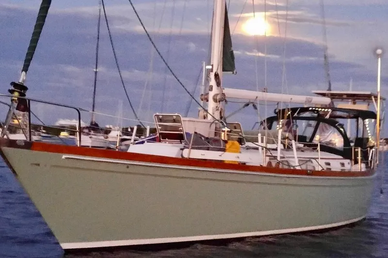 Slide: The Image of 1981 Bristol 45.5 Aft Cockpit sailboat on water at sunset. - 47