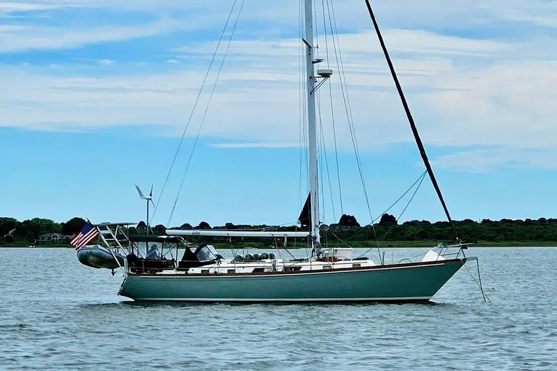 Slide: The Image of 1981 Bristol 45.5 Aft Cockpit sailboat on calm water with clear sky background. - 50