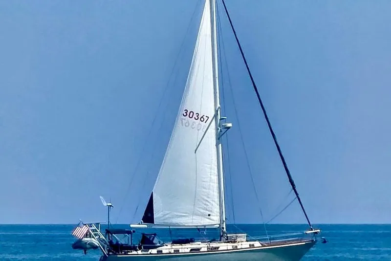 Slide: The Image of 1981 Bristol 45.5 Aft Cockpit sailboat on open sea with clear blue sky. - 51