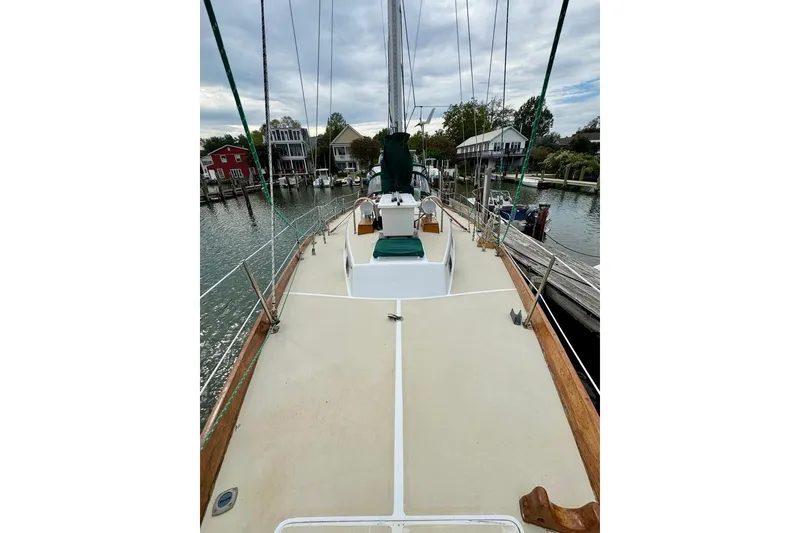 Slide: The Image of 1981 Bristol 45.5 Aft Cockpit sailboat docked, showcasing spacious deck and marina view. - 7