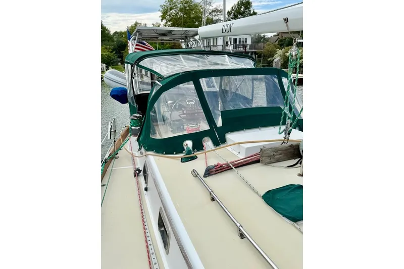 Slide: The Image of 1981 Bristol 45.5 Aft Cockpit sailboat with green canopy, docked in a marina. - 9