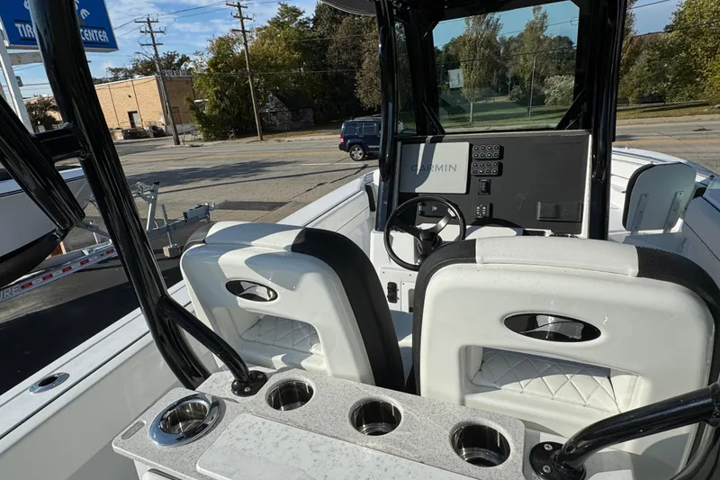 Slide: The Image of 2026 Stingray 253 CC boat interior with steering console and cup holders. - 10