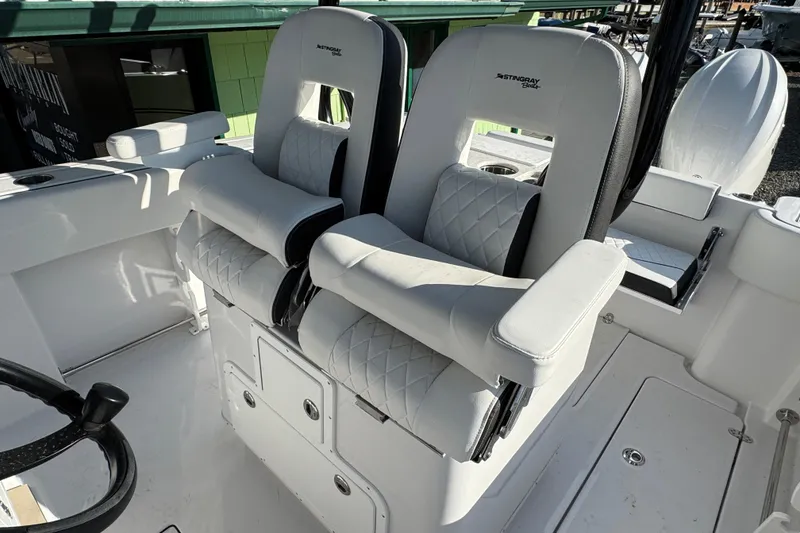 Slide: The Image of 2026 Stingray 253 CC boat interior with luxurious white seating and modern design. - 12