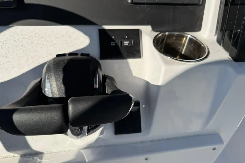 Slide: The Image of 2026 Stingray 253 CC boat console with throttle and cup holder. - 16