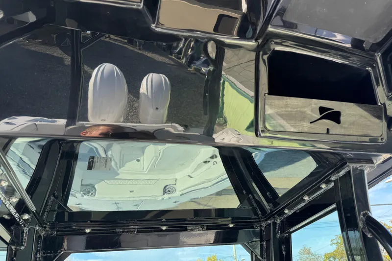 Slide: The Image of 2026 Stingray 253 CC boat interior with reflective surfaces and dual engines visible. - 17