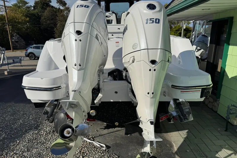 Slide: The Image of 2026 Stingray 253 CC boat with dual Yamaha 150 outboard engines, rear view. - 2