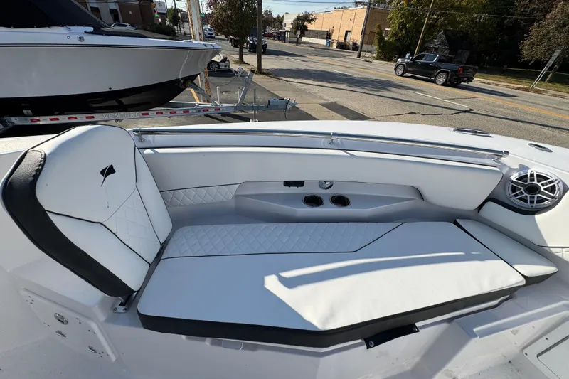 Slide: The Image of 2026 Stingray 253 CC boat interior with white cushioned seating and speaker system. - 20