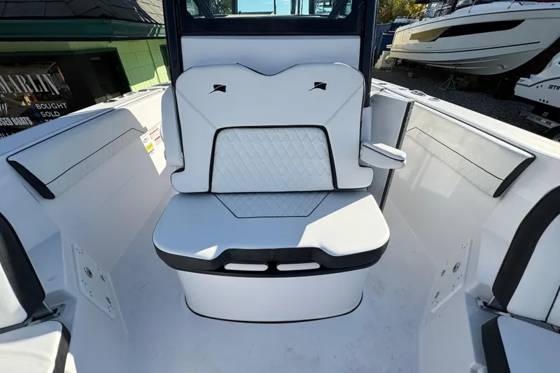 Slide: The Image of 2026 Stingray 253 CC boat interior with white seating and diamond stitching. - 22