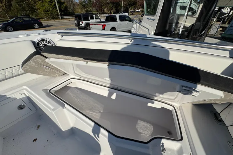 Slide: The Image of 2026 Stingray 253 CC boat interior with open storage compartment and seating area. - 25
