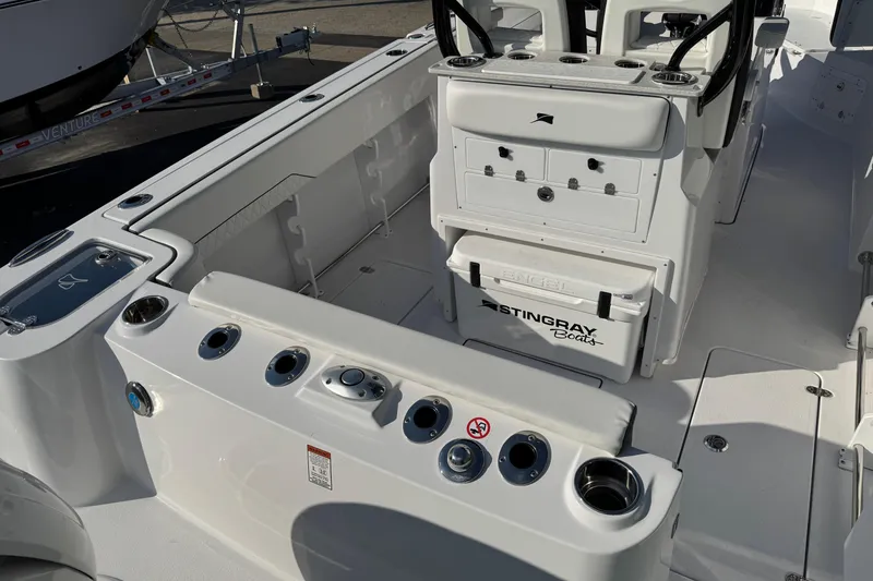 Slide: The Image of 2026 Stingray 253 CC boat interior with storage compartments and cup holders. - 3
