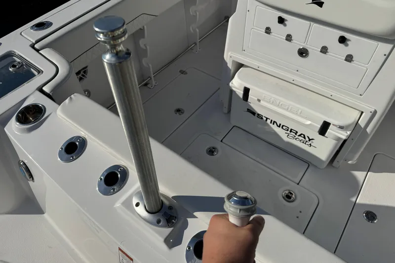 Slide: The Image of 2026 Stingray 253 CC boat interior with rod holders and storage compartments. - 4
