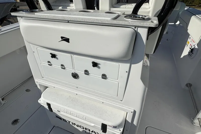 Slide: The Image of 2026 Stingray 253 CC boat interior with storage compartments and Engel cooler. - 7