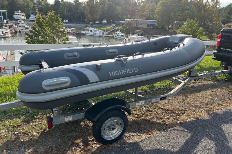 The Image of 2024 Highfield Classic 310 inflatable boat on trailer near marina. - 1