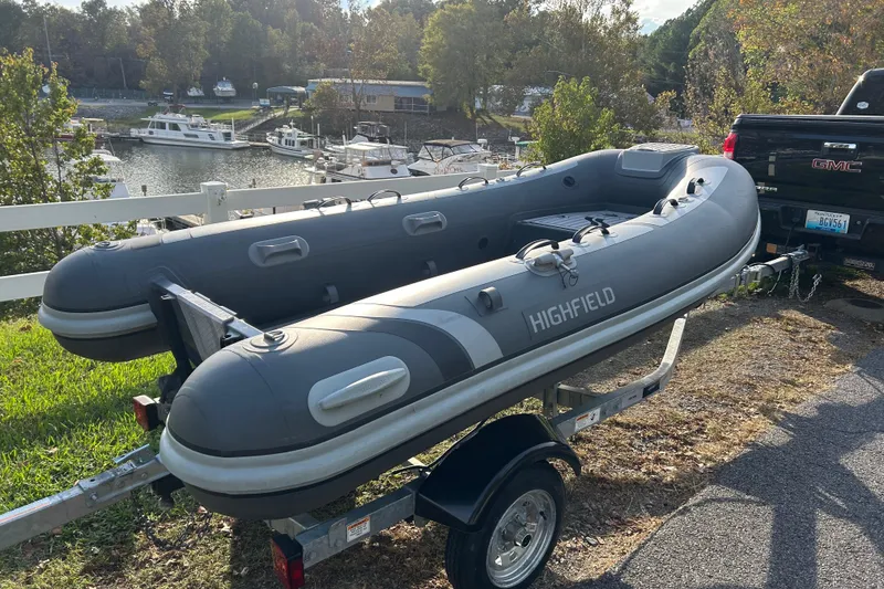 Slide: The Image of 2024 Highfield Classic 310 inflatable boat on trailer near marina. - 4
