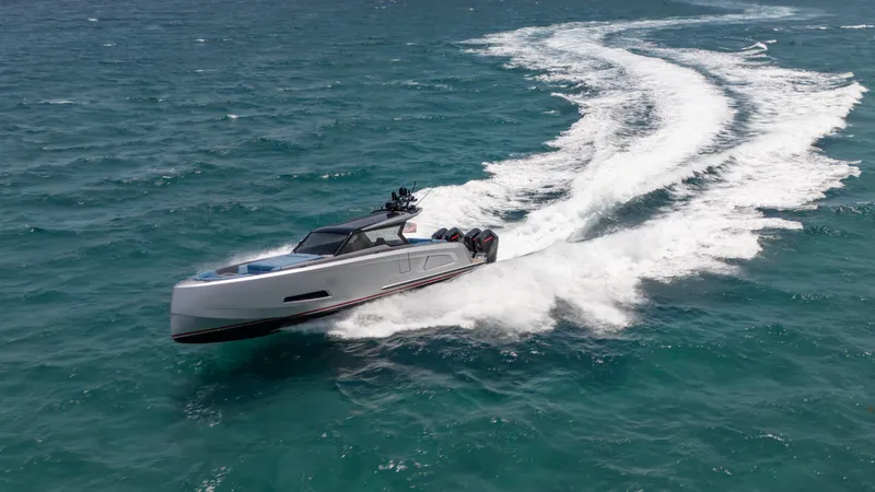 Slide: The Image of 2023 Vanquish Yachts VQ45 speeding on open water, creating dynamic waves. - 10