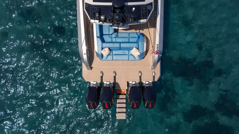 Slide: The Image of Aerial view of 2023 Vanquish Yachts VQ45 with four engines on clear blue water. - 15