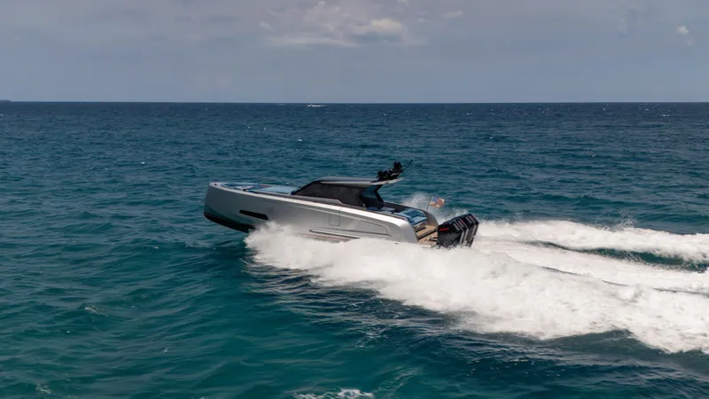 Slide: The Image of 2023 Vanquish Yachts VQ45 cruising on open sea, creating dynamic waves. - 19