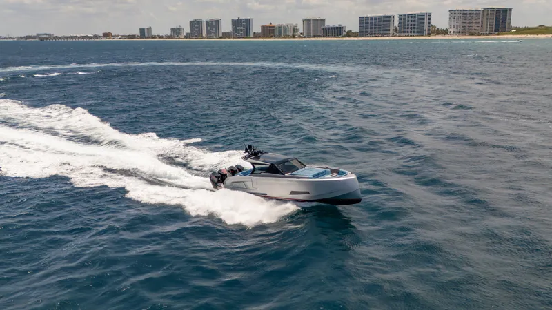 Slide: The Image of 2023 Vanquish Yachts VQ45 cruising on ocean near city skyline. - 22