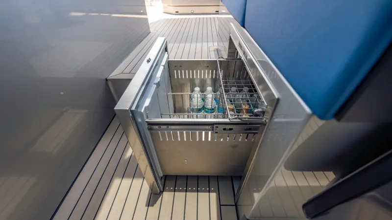 Slide: The Image of Stainless steel drawer fridge on 2023 Vanquish Yachts VQ45, stocked with bottled drinks. - 28