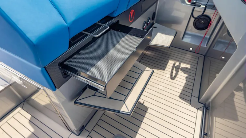 Slide: The Image of 2023 Vanquish Yachts VQ45 interior with blue seating and sleek storage compartments. - 31