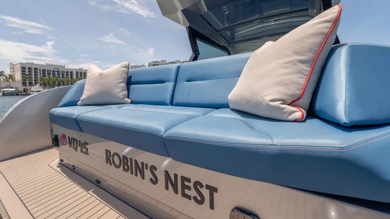 Slide: The Image of 2023 Vanquish Yachts VQ45 with blue seating and cushions, named "Robin's Nest." - 38