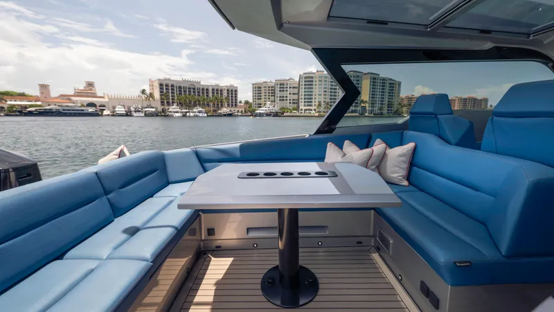 Slide: The Image of Luxurious 2023 Vanquish Yachts VQ45 interior with blue seating and waterfront view. - 41