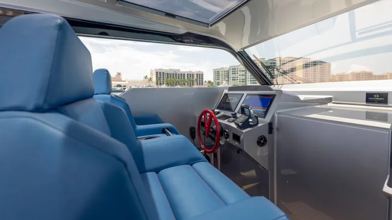 Slide: The Image of Interior of 2023 Vanquish Yachts VQ45 with blue seating and modern dashboard. - 45