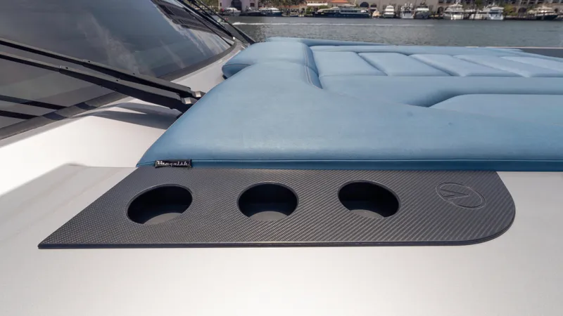 Slide: The Image of 2023 Vanquish Yachts VQ45 deck with blue seating and cup holders. - 48