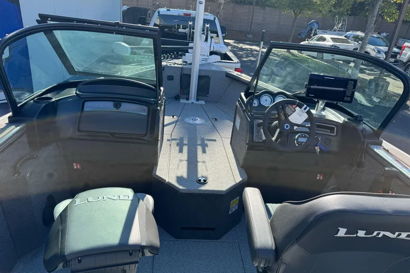 Slide: The Image of Interior view of 2026 Lund 2075 Fisherman boat, featuring steering console and seating. - 12