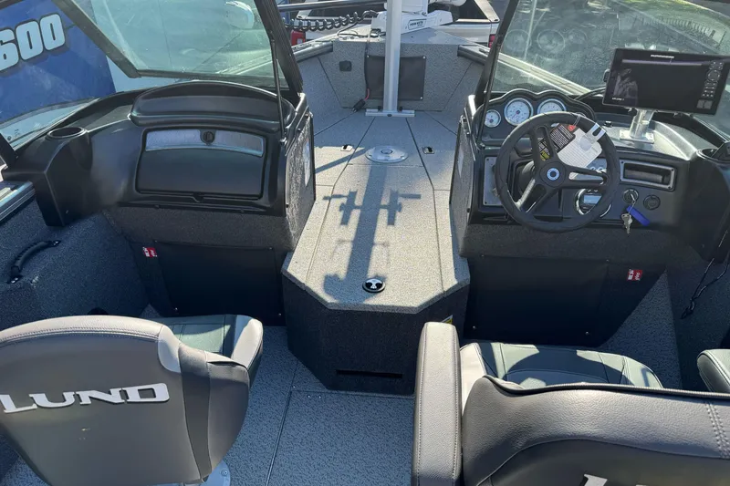Slide: The Image of Interior view of 2026 Lund 2075 Fisherman boat, featuring steering wheel and seating. - 13