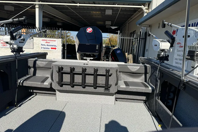 Slide: The Image of 2026 Lund 2075 Fisherman boat interior with seating and fishing rod holders. - 14