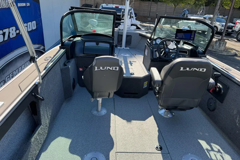 Slide: The Image of 2026 Lund 2075 Fisherman boat interior with dual seats and steering console. - 18
