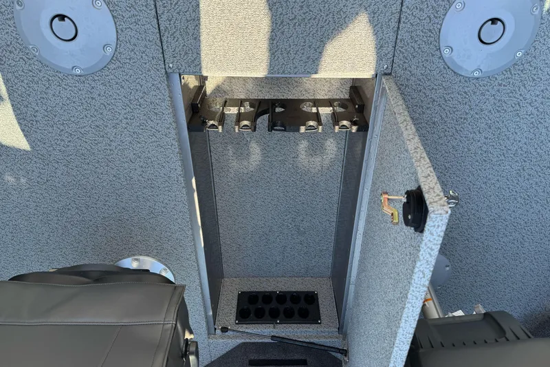 Slide: The Image of 2026 Lund 2075 Fisherman boat interior storage compartment with open door and seating. - 19